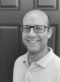 Headshot of Scott Rothman. Smiling man with glasses.
